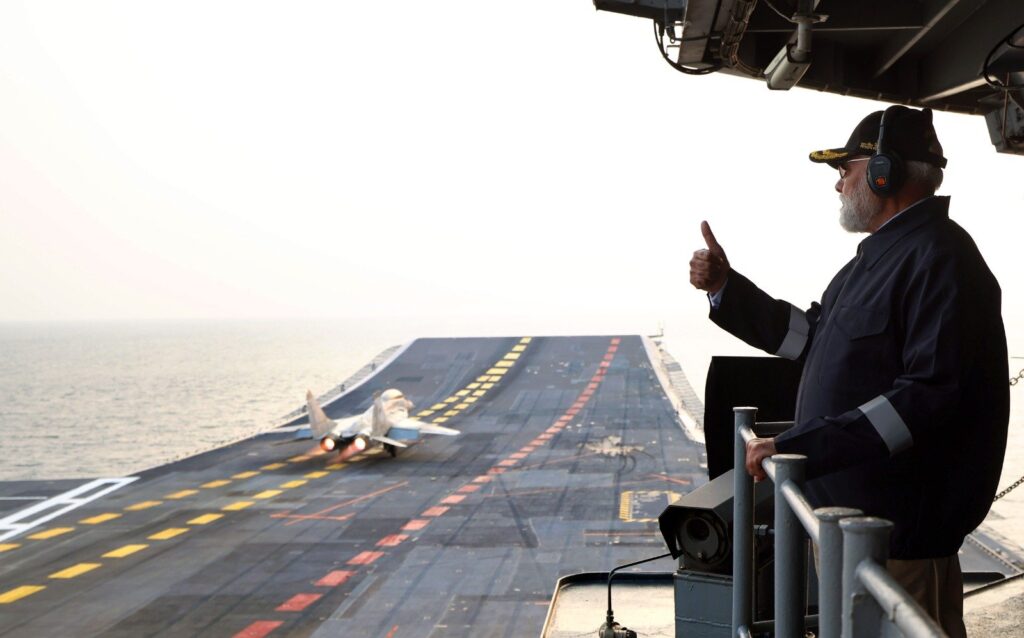 Indian Prime Minister Narendra Modi sees take-off and landing of a MiG-29 fighter jet on board INS Vikrant on Diwali 2025