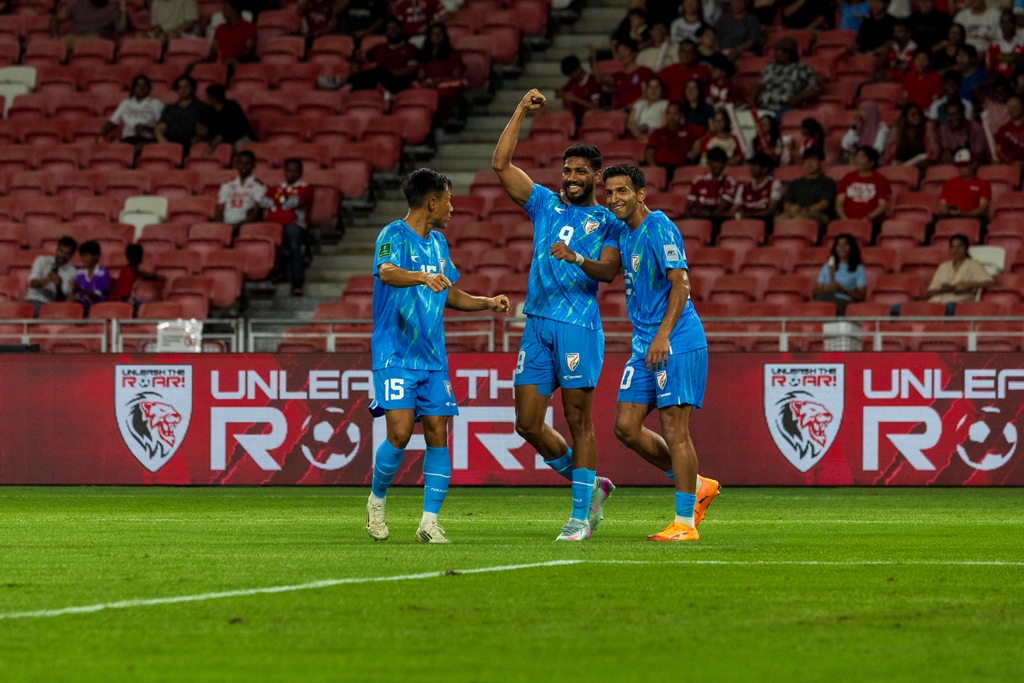 Rahim Ali and teammates celebrate a goal against Singapore