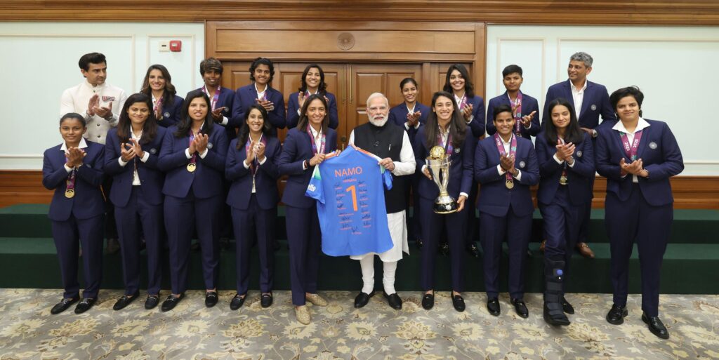 The Indian women’s cricket team with PM Modi and a team jersey