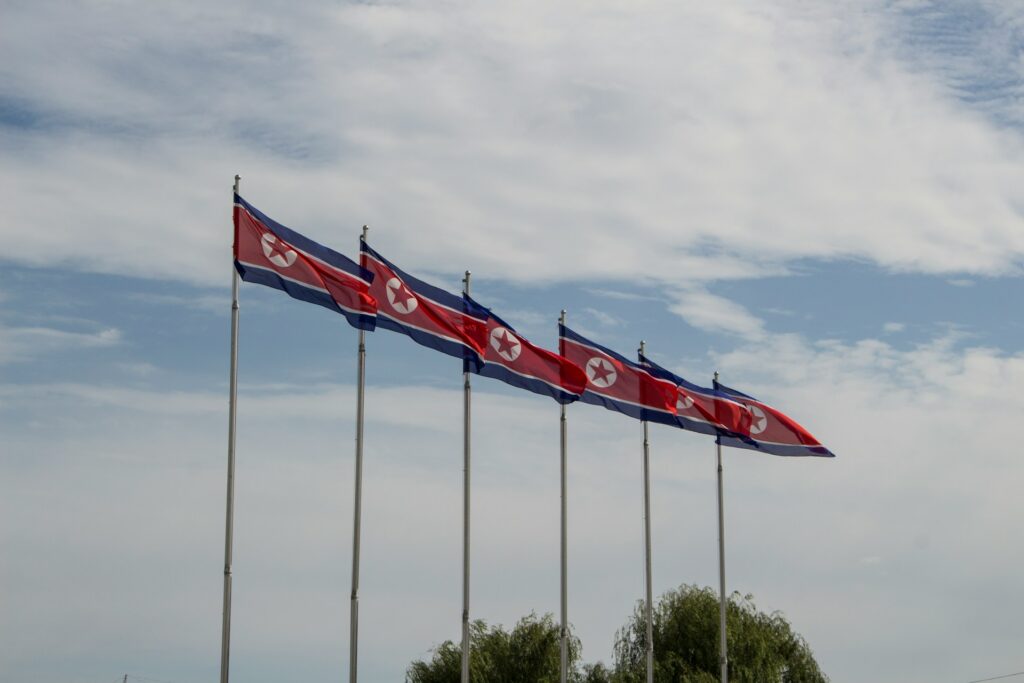 Flags if North Korea fluttering in the wind.