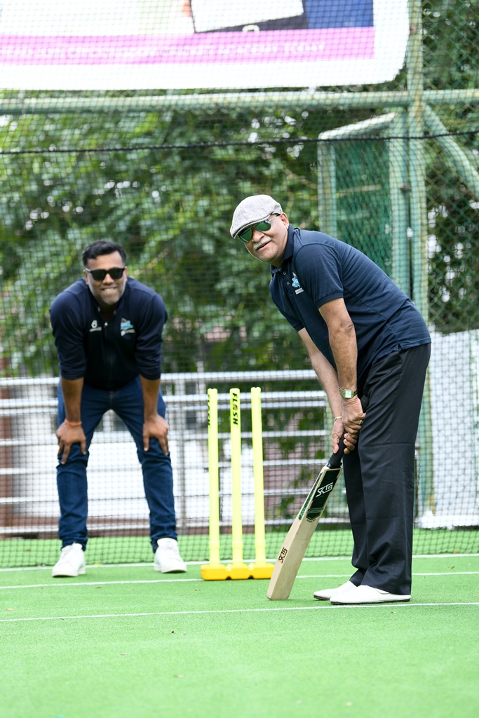 Vishal Sharma (back) keeping stumps while Gurunath Sharma bats.